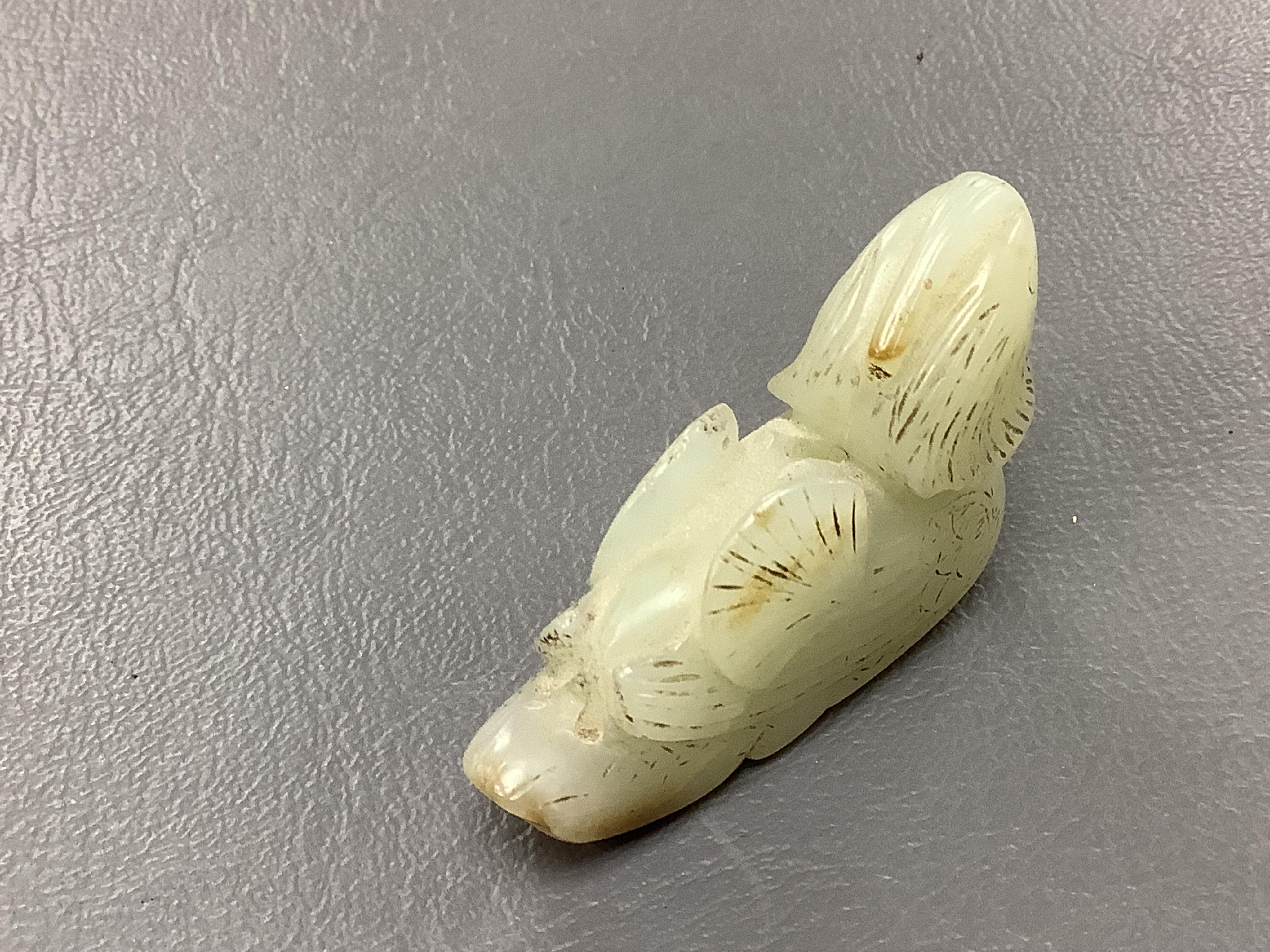 A Chinese jade figure of a Mandarin duck and a miniature pot and cover, three jadeite carvings and a bowenite dragon, 16.5cm